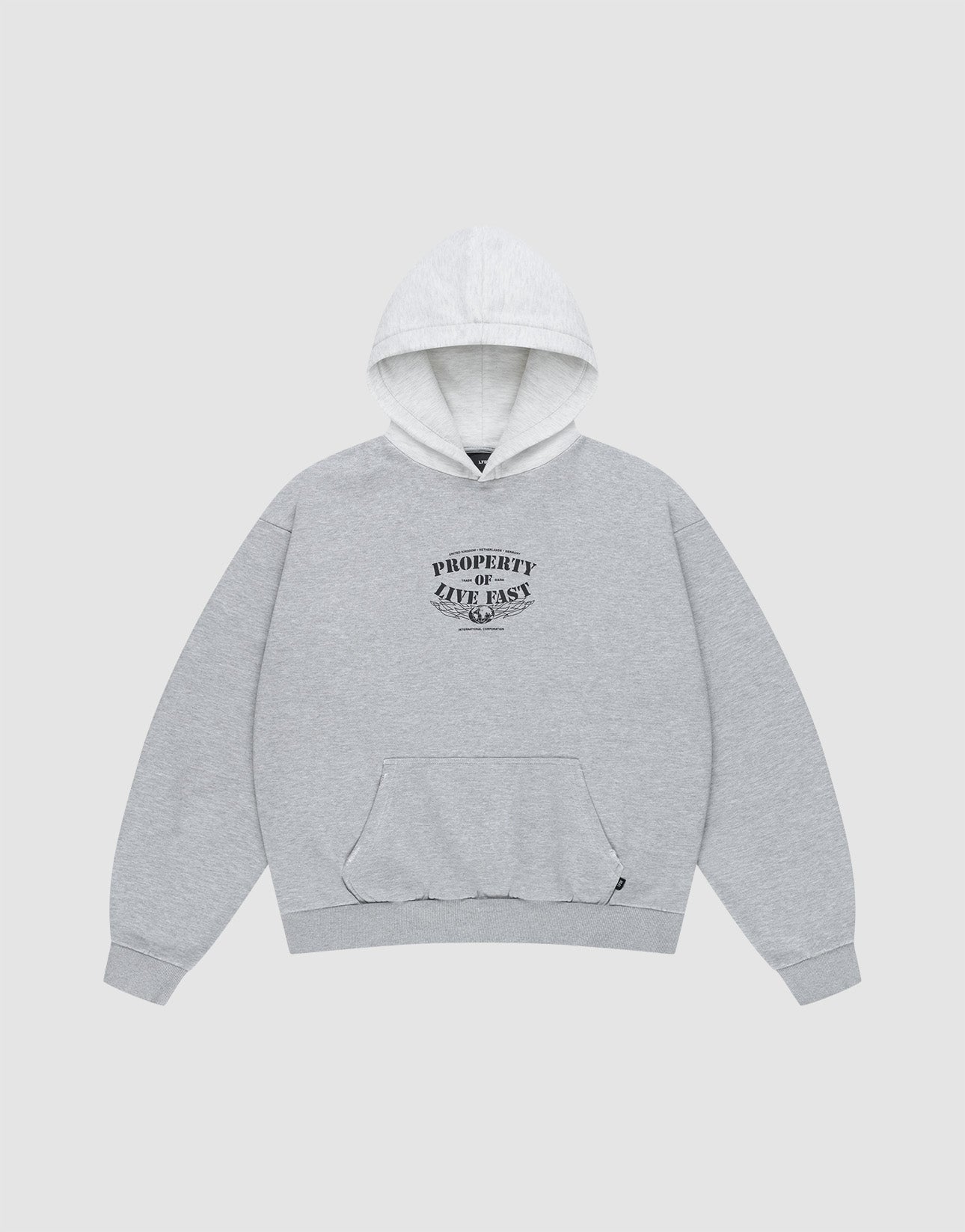 The Live Fast Property Hooded by LIVE FAST DIE YOUNG is a light heather grey oversized hoodie with a front pocket, soft cotton-polyester blend, and black curved "Property ZAVO FAST" text, shown on a plain white background.