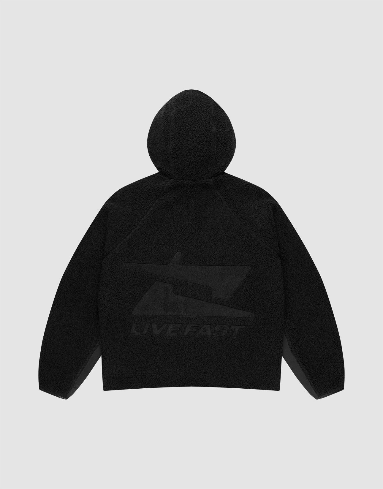 The Live Fast Teddy Jacket by LIVE FAST DIE YOUNG is shown from the back in black, with a large subtle stylized gun graphic and "LIVE FAST" near the hem. Raglan sleeves add comfort and style. Set against a light gray background.