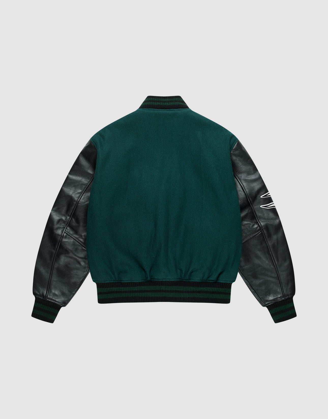 The Life College Jacket by LIVE FAST DIE YOUNG features green fabric, black leather sleeves, ribbed cuffs and waistband, a white embroidered detail on the right sleeve, and a terry patchāshown from the back on a light gray background.