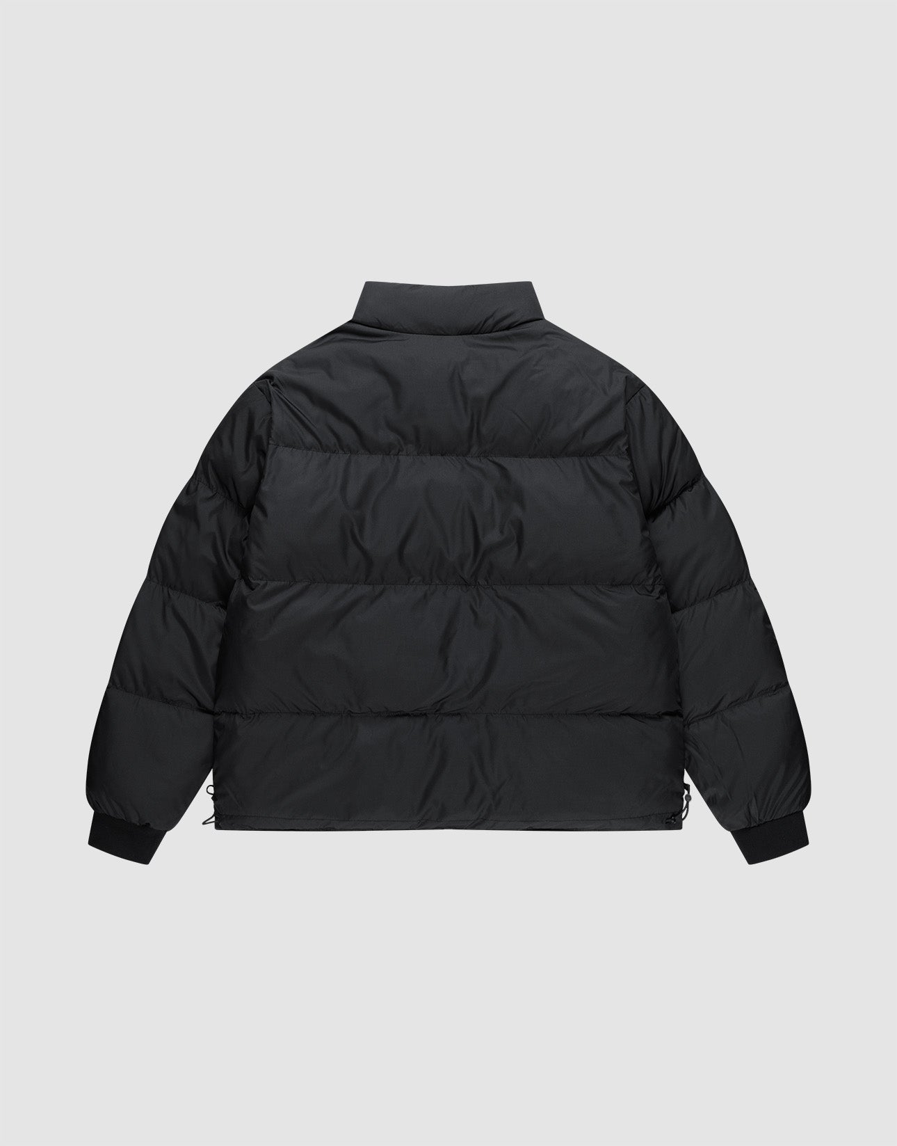 A back view of the LFDY Puffer Jacket by LIVE FAST DIE YOUNG in black, featuring a high collar, horizontal quilting, and an oversized fit for comfort and style, shown against a plain light gray background.