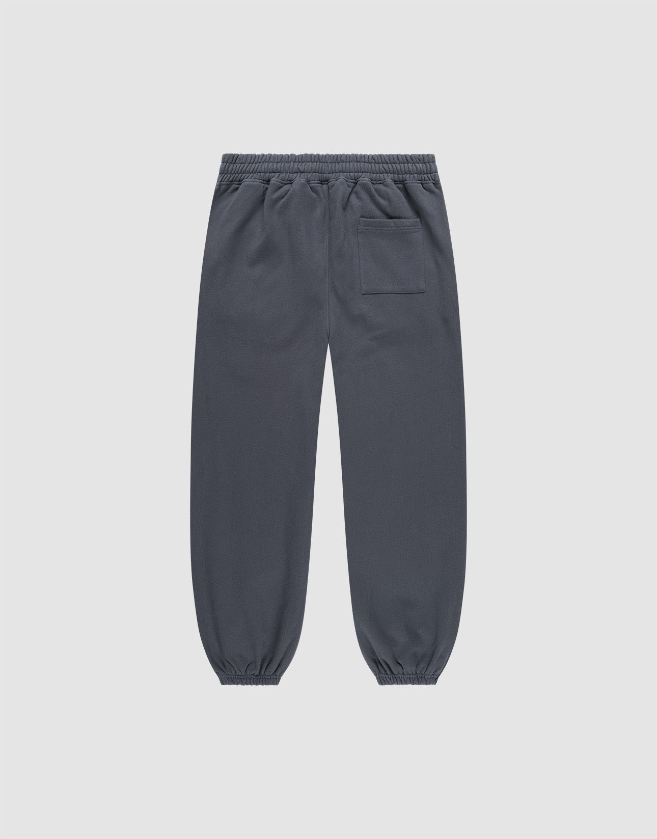 The DY Loose Jogger by LIVE FAST DIE YOUNG are dark gray, loose fit sweatpants with an elastic waistband, elastic cuffs, and a single back patch pocket, crafted from soft cotton and shown flat on a light gray background.