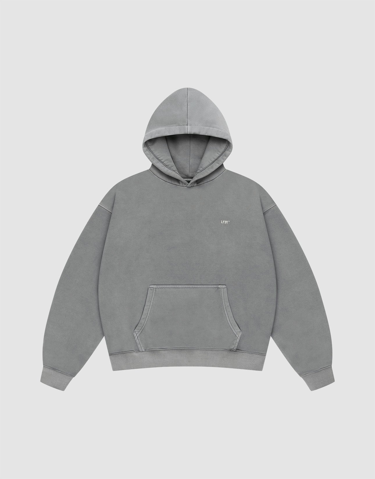 The LIVE FAST DIE YOUNG Basic Evidence Hooded is a plain gray oversized hoodie with a front pocket, hood, and small white text on the left chest. It’s styled against a plain white background.
