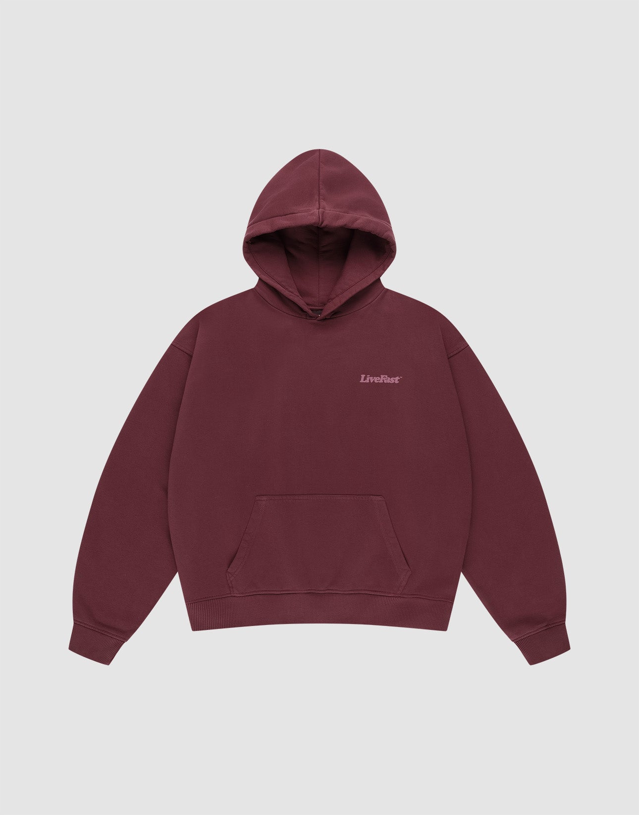 The Basic 360 Hooded by LIVE FAST DIE YOUNG is a maroon cotton hoodie with a front pocket, small "LiveFast" text on the left chest, and an oversize fit, shown against a plain light gray background.