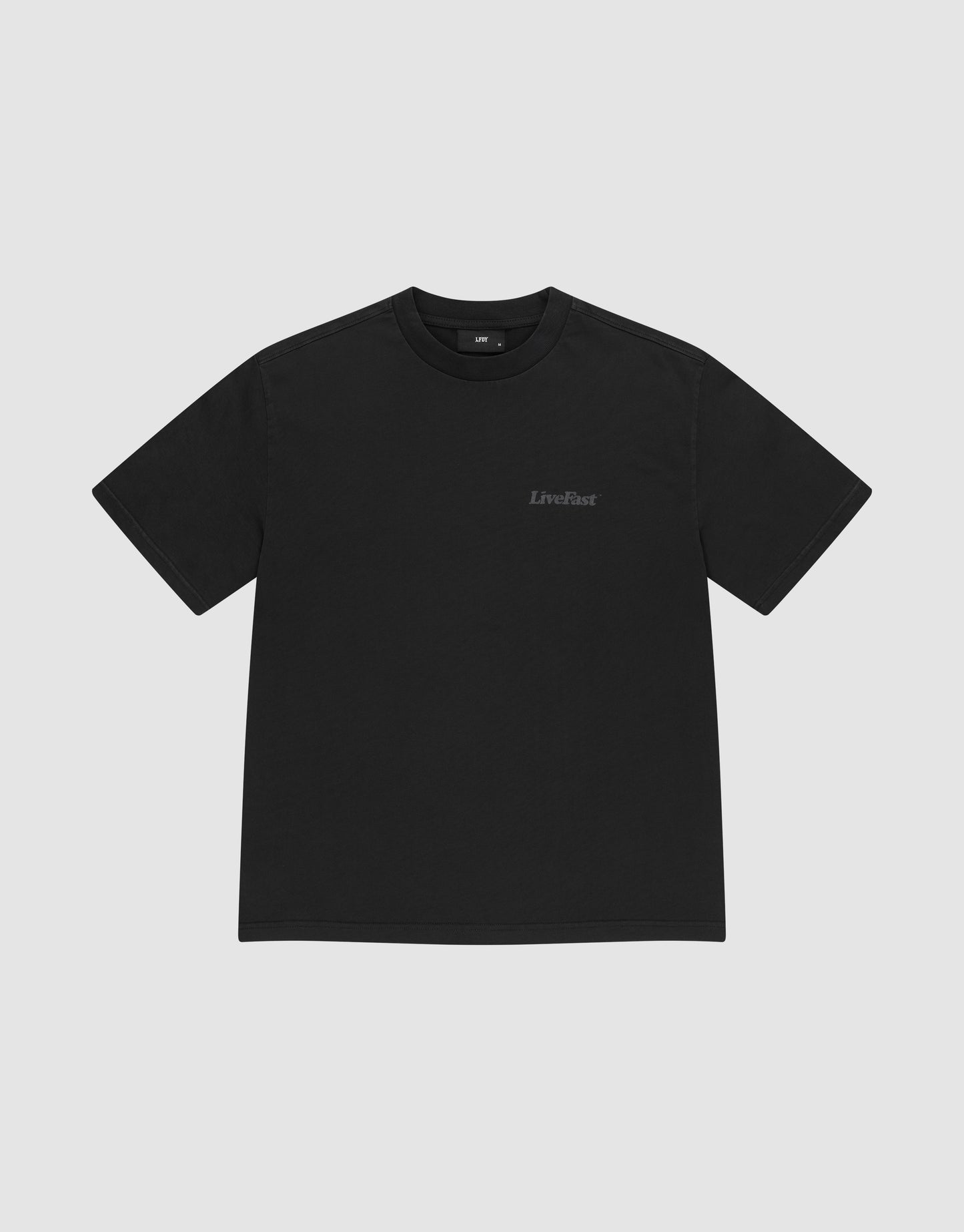 The LIVE FAST DIE YOUNG Basic 280 Tee is a plain black, short-sleeve t-shirt made from 100% Baumwolle, featuring a small LiveFast logo on the left chest and shown on a light gray background.