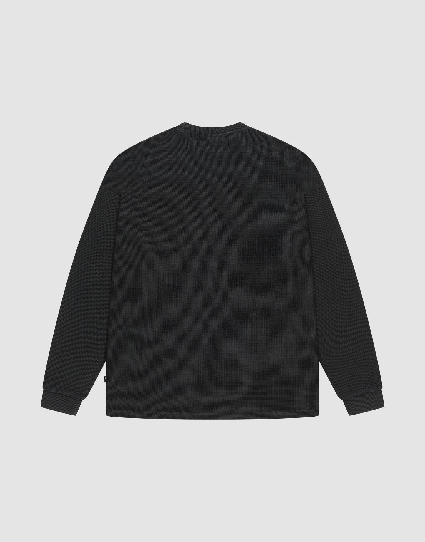 The LIVE FAST DIE YOUNG Blank Waffle Longsleeve is an oversized black shirt with a crew neckline, displayed from the back against a light gray background.