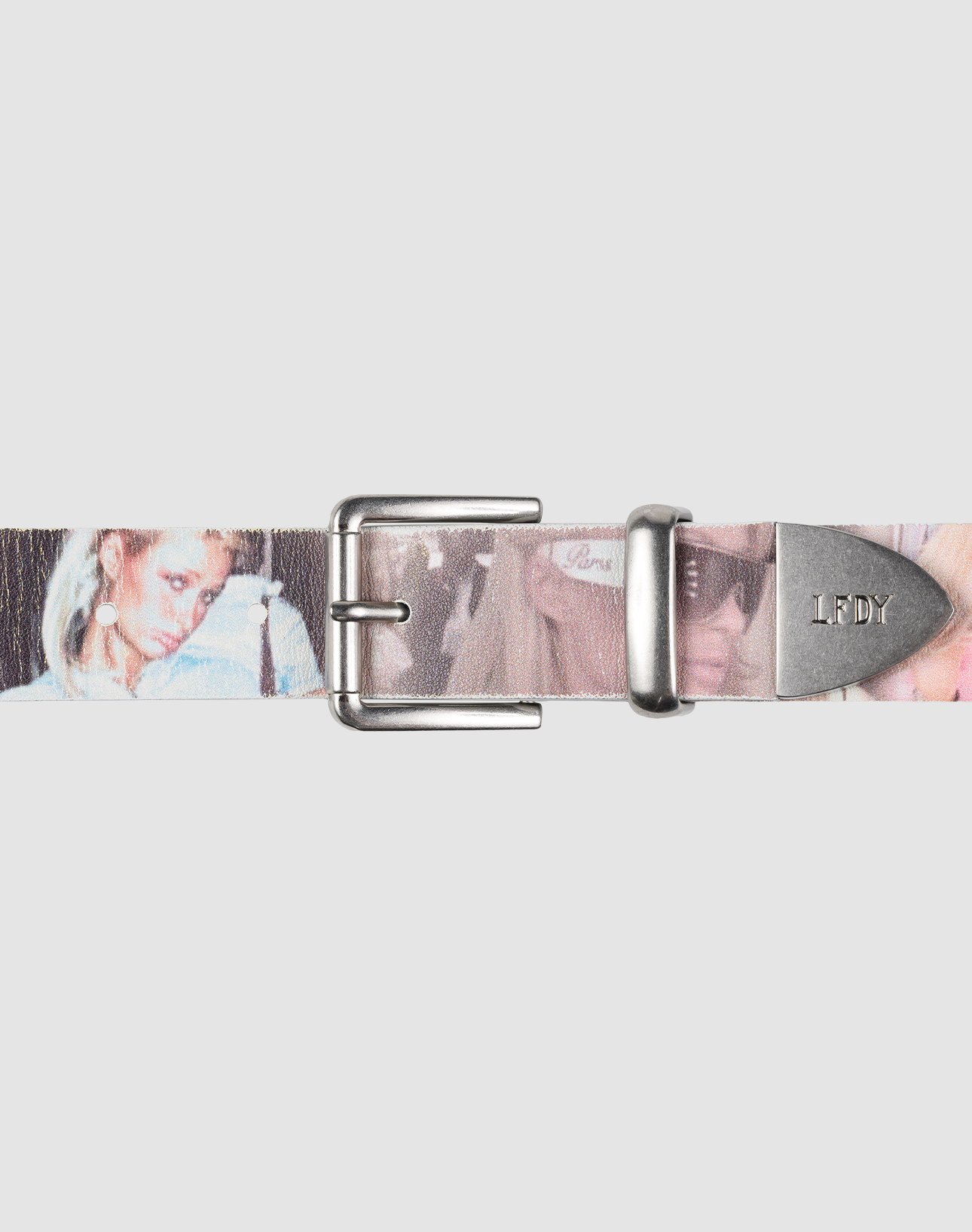 The LFDY Iconic Belt by LIVE FAST DIE YOUNG features printed leather with faded women’s images, a metal buckle, and an LFDY-engraved tip. The light gray background highlights this accessory's unique style. | model