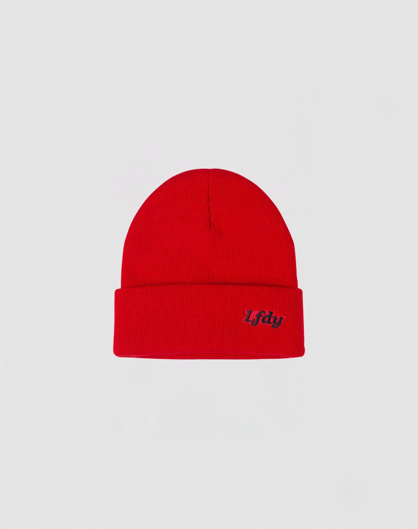 The LFDY Beanie by LFDY is a bright red polyacryl hat with a folded cuff and a small black Lfdy logo embroidered on the front, shown against a light gray background.