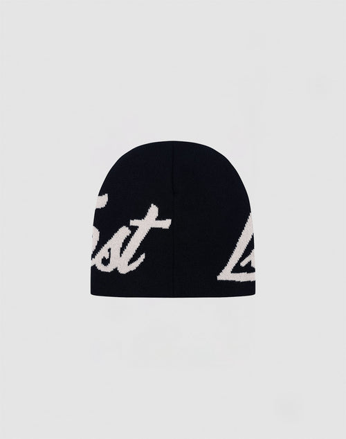 The LFDY Jacquard Beanie by LIVE FAST DIE YOUNG is a black polyacryl hat with bold white Logo Strick script, partially visible, photographed on a plain light gray background.