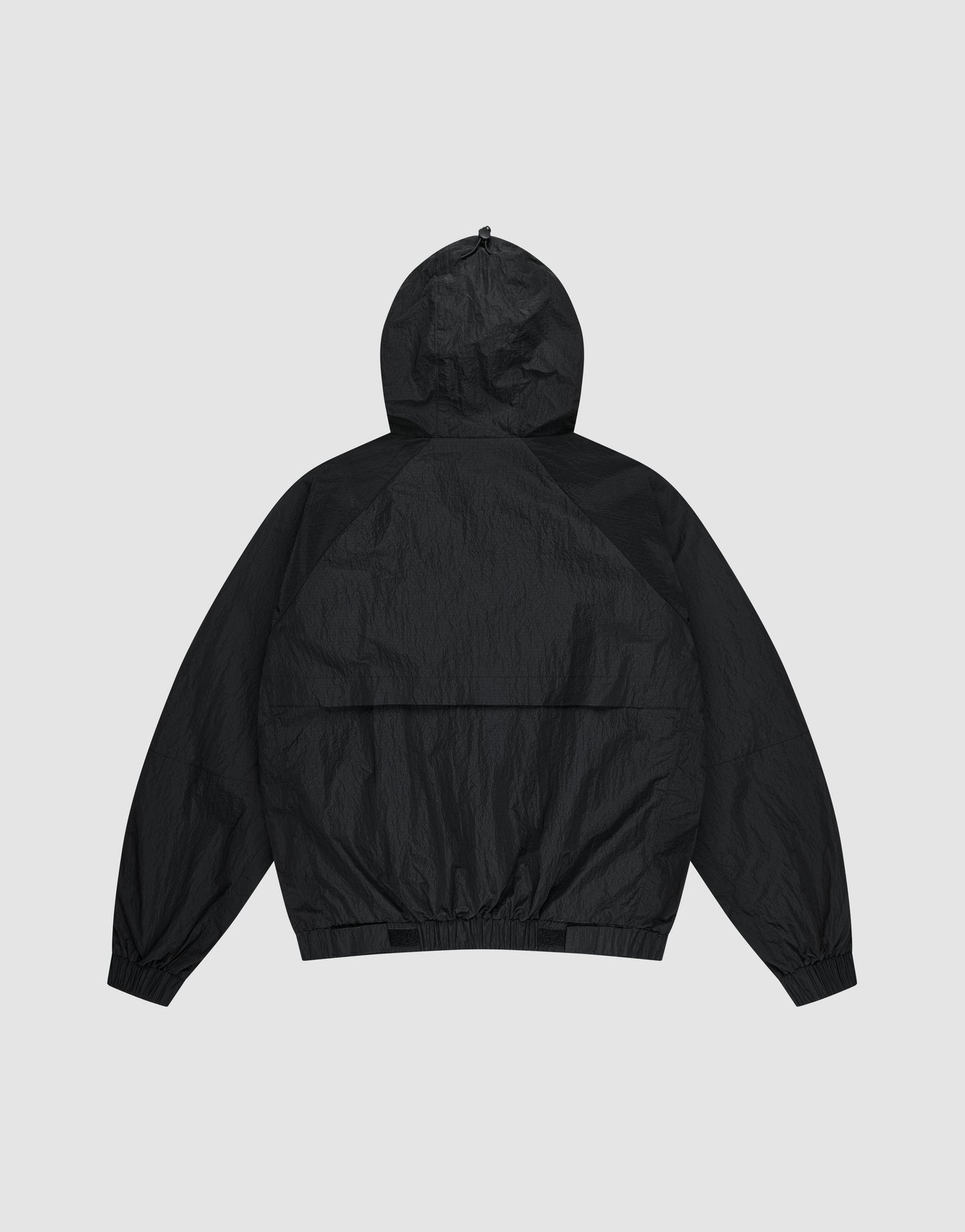 The Live Fast Nylon Jacket by LIVE FAST DIE YOUNG is shown flat from the back, featuring an oversized fit, long sleeves, elastic cuffs, and waistband, set against a light gray background.