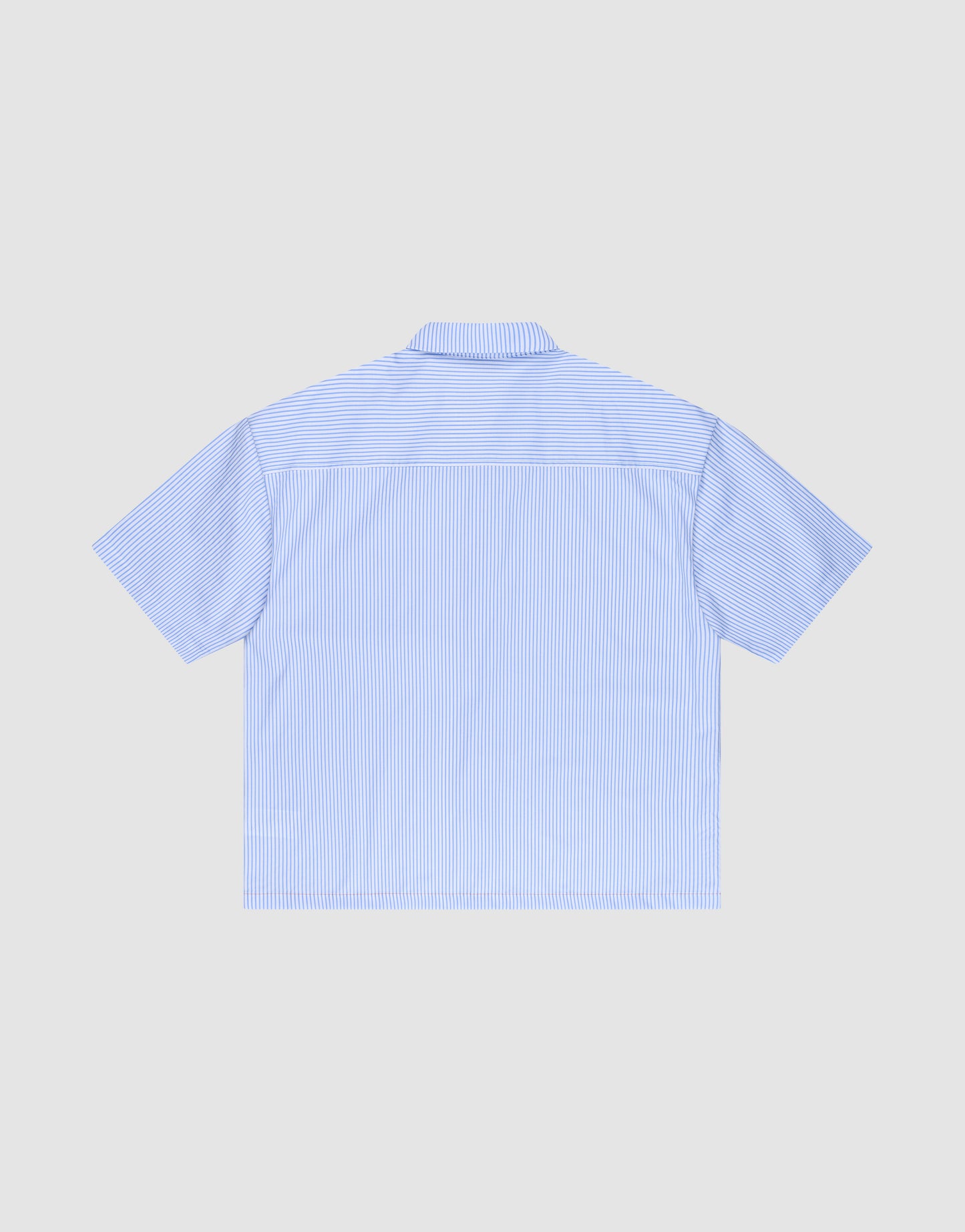 A light blue and white vertically striped LFDY Striped Boxy Shirt by LIVE FAST DIE YOUNG with short sleeves, logo-stitch, oversize fit, shown from the back and laid flat on a plain light gray background.