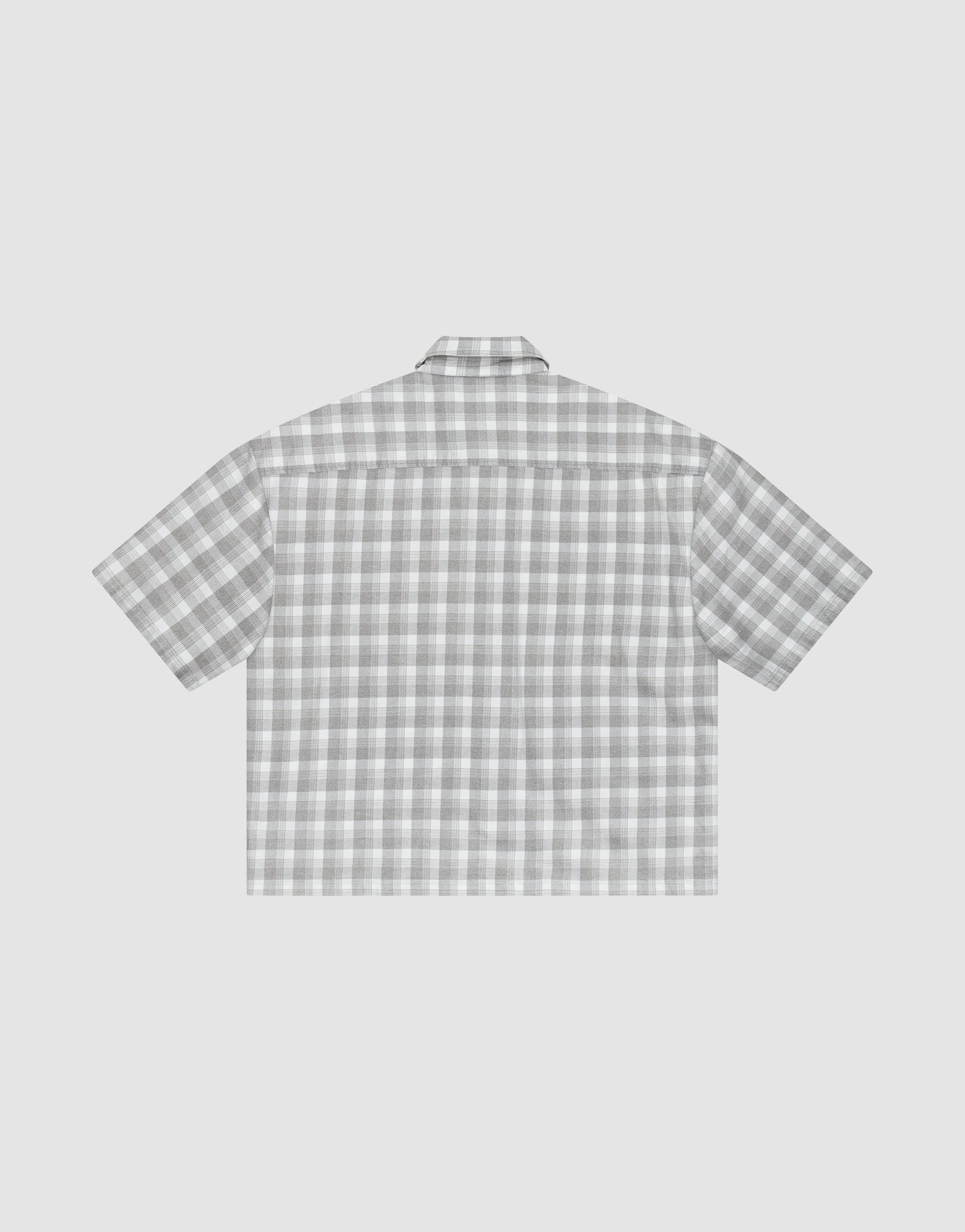The LIVE FAST DIE YOUNG LFDY Light Flannel is a short-sleeve, button-up shirt shown flat with its back up, featuring a gray and white plaid design, straight hem, and relaxed oversize fit.