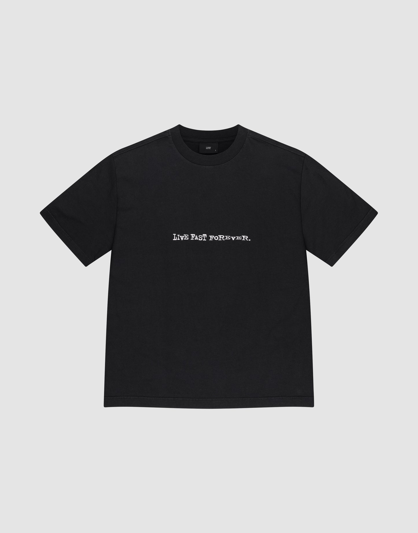 The LFDY We Walked Tee by LIVE FAST DIE YOUNG is a plain black, oversized cotton short-sleeve t-shirt with "LIVE FAST FOREVER." in bold white letters across the chest, shown against a light gray background.