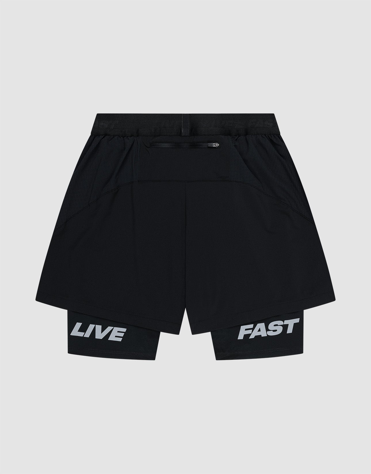 LIVE FAST DIE YOUNG Live Fast Performance Running Shorts feature an overlapping black design with āLIVEā on the left inner leg and āFASTā on the right in bold white. Regular fit, shown on a plain light background.
