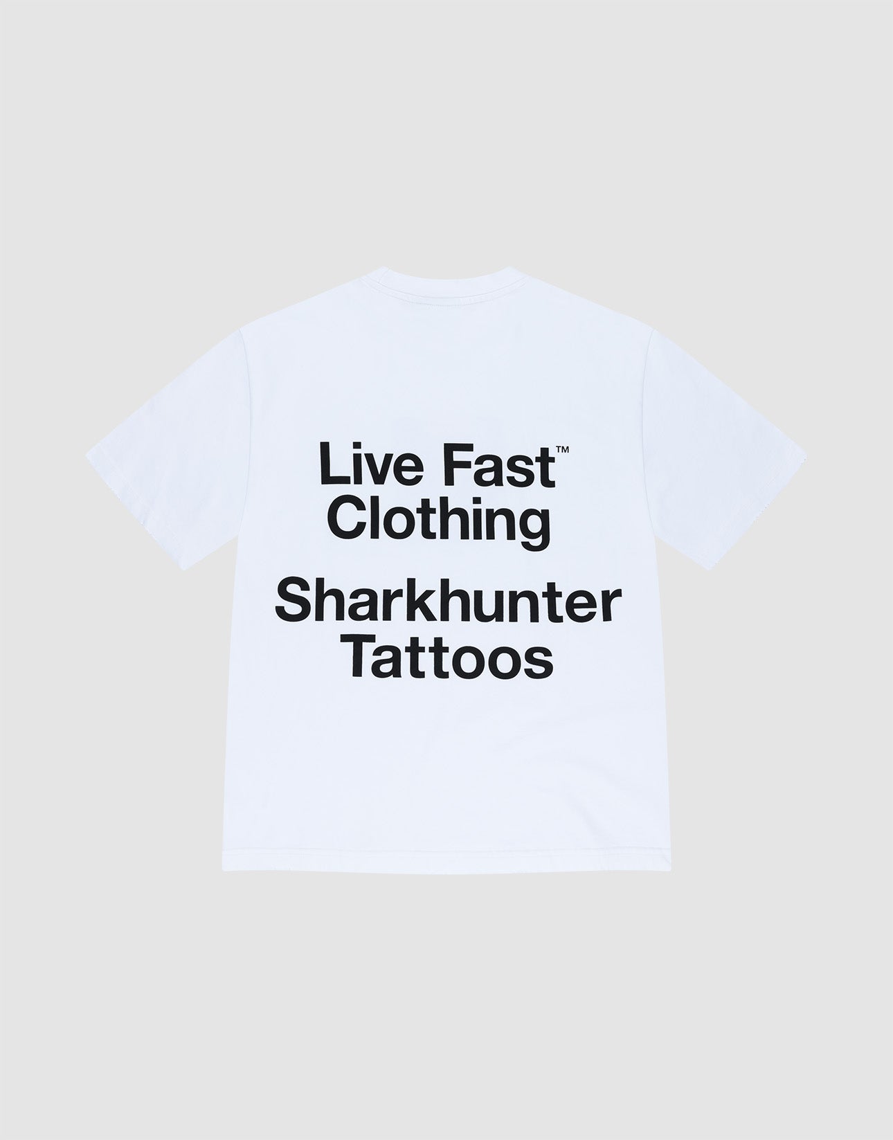 The LFDY Sharkhunter Tee by LIVE FAST DIE YOUNG is a white oversized 100% cotton T-shirt with bold black "Sharkhunter Tattoos" text on the back, shown against a plain light gray background.