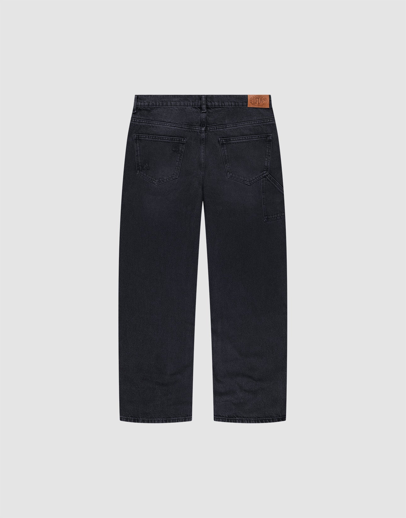 The Oversize Ripped Denim jeans by LIVE FAST DIE YOUNG feature a straight leg, two back pockets, and a brown leather patch on the waistband, shown from the back against a plain light gray background.