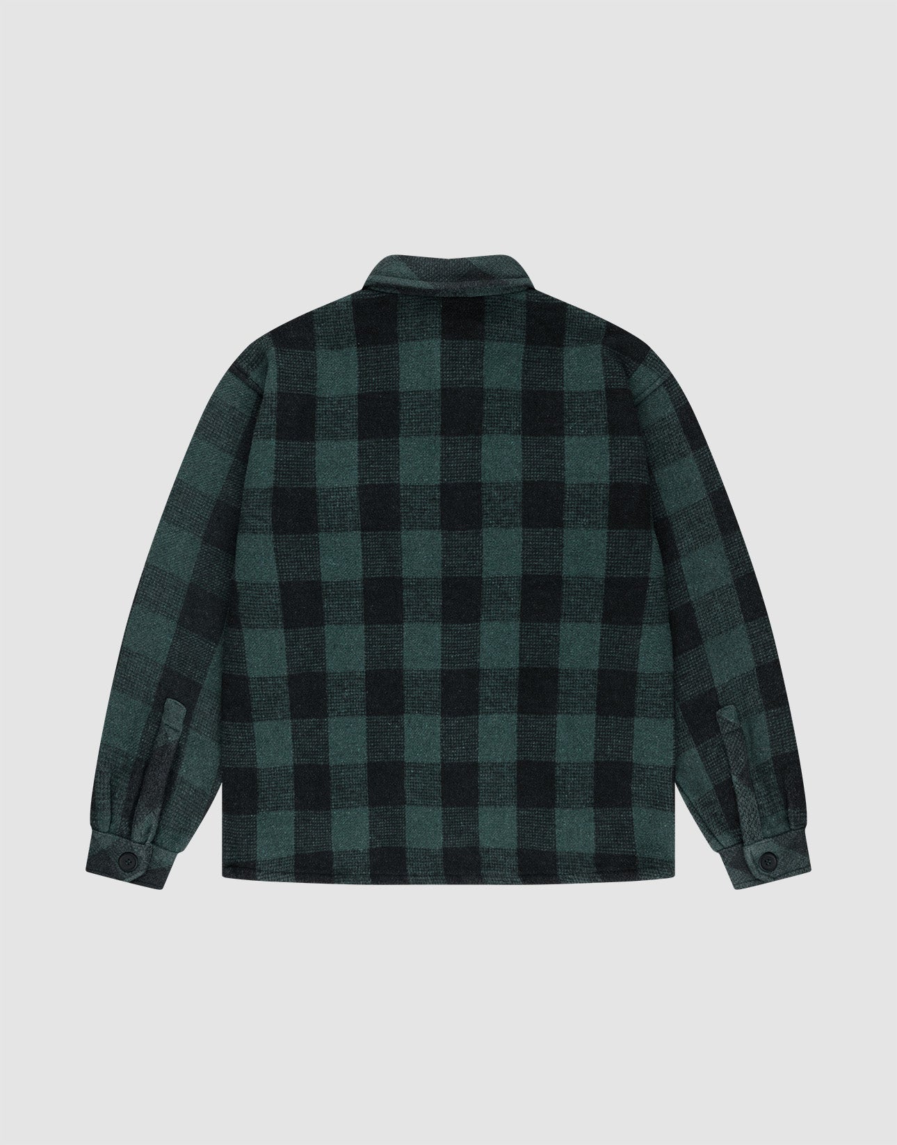 A back view of the LIVE FAST DIE YOUNG Heavy Flannel Shacket in a regular fit, featuring a large dark green and black checkered pattern, buttoned cuffs, and a straight hem on a plain light background.