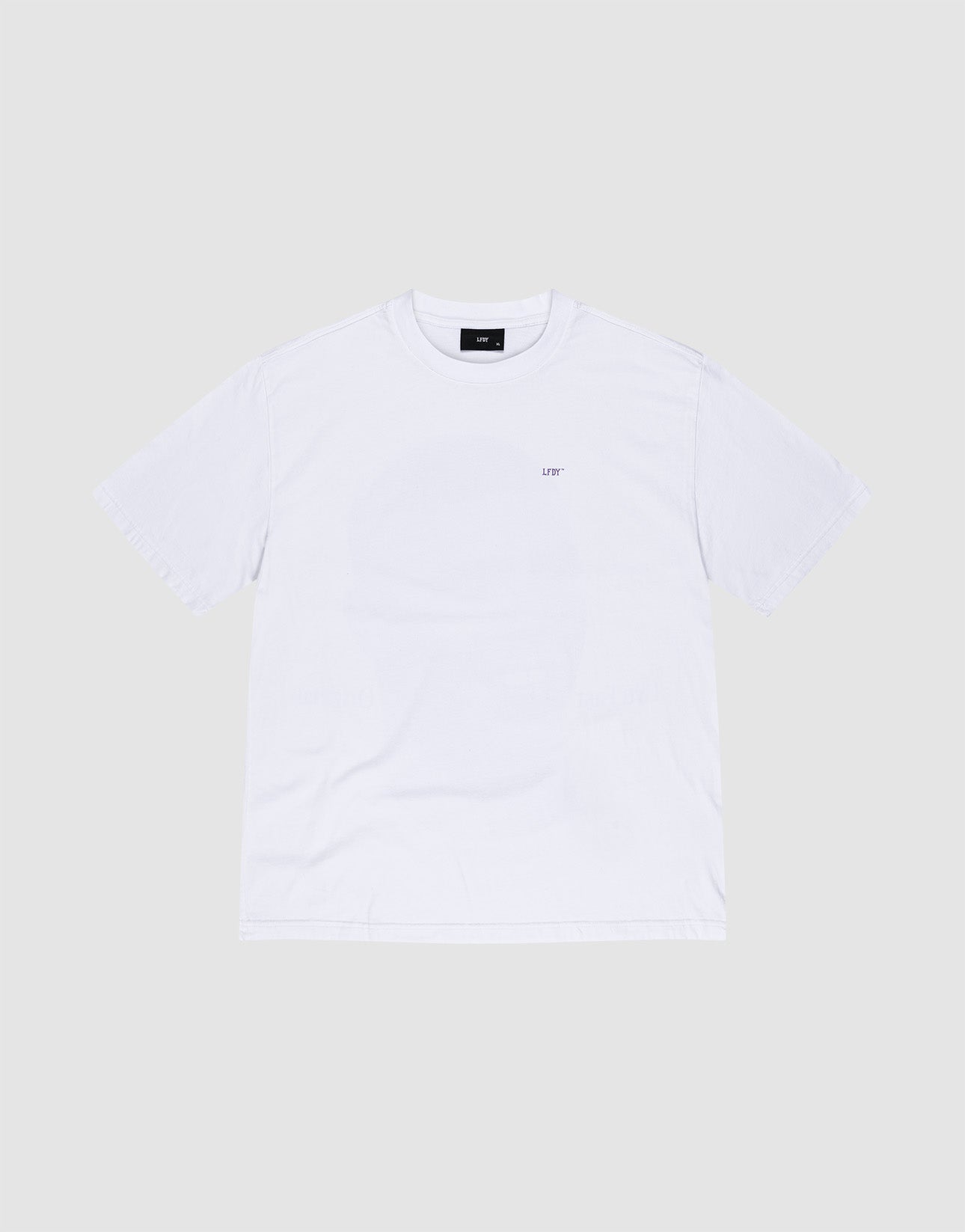 The LFDY Originals Tee by LIVE FAST DIE YOUNG is an oversized white short-sleeve shirt, flat on a light grey background, featuring a small black LIFT logo on the left chest. Crafted from 100% Baumwolle for comfort.