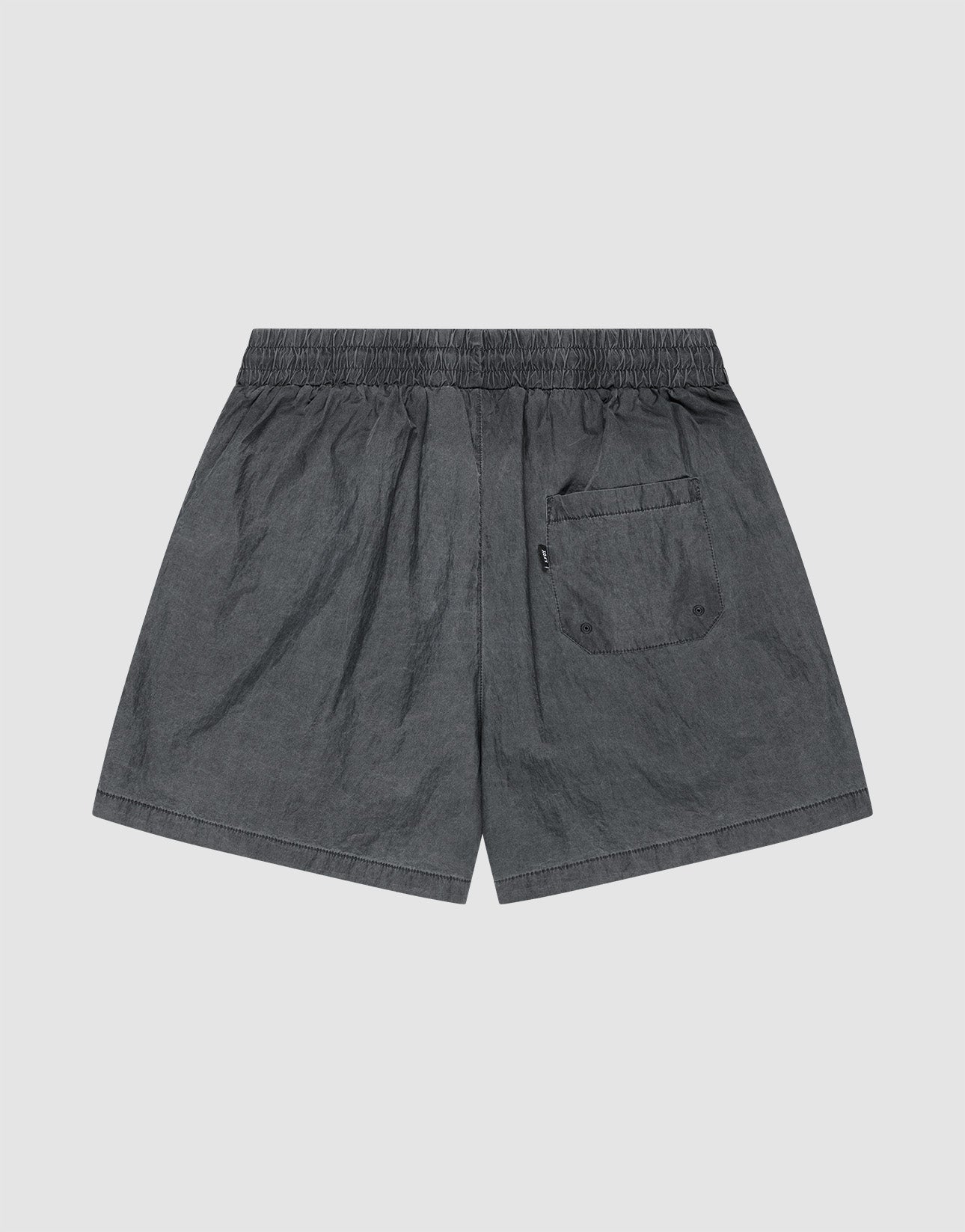 The LIVE FAST DIE YOUNG Live Fast Swimshorts feature a dark gray tinted black wash, elastik-bund waistband, single back flap pocket with two buttons, and lightweight fabric with a slightly wrinkled look in a regular fit.