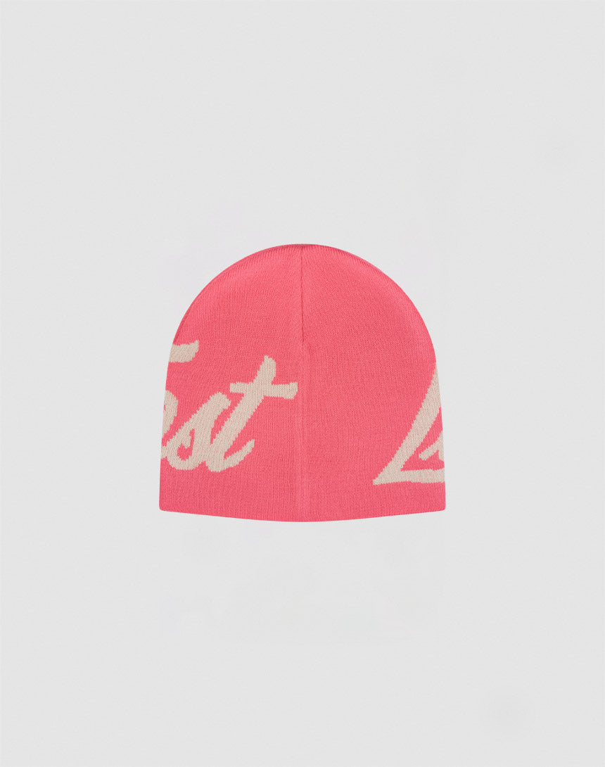 The LFDY Jacquard Beanie by LIVE FAST DIE YOUNG is a pink Polyacryl beanie with bold white cursive logo text, shown against a plain light gray background.
