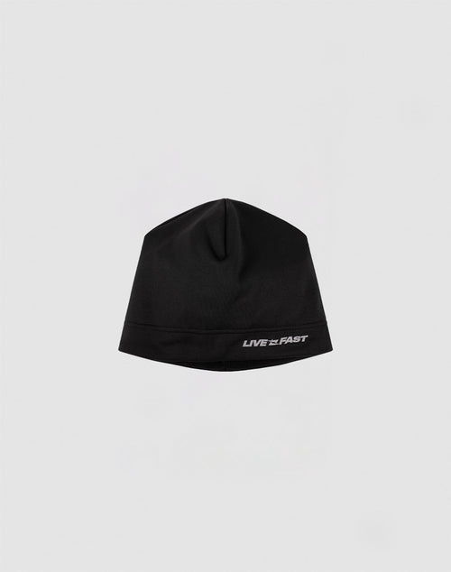 The Live Fast Performance Beanie by LIVE FAST DIE YOUNG features a black fitted design with a reflective LIVE FAST logo near the brim, shown against a plain light gray background.