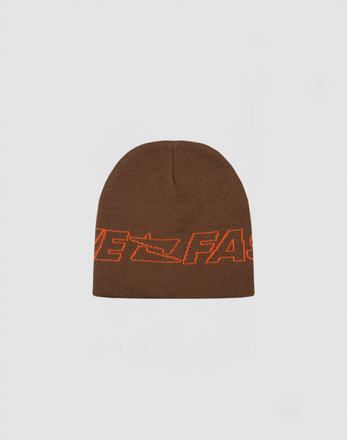 The Live Fast Jacquard Beanie by LIVE FAST DIE YOUNG is a brown 100% Polyacryl knit, featuring bold orange FAST lettering and a Logo Strick arrow design. Shown on a light gray background. Style code: LF2410-16485.