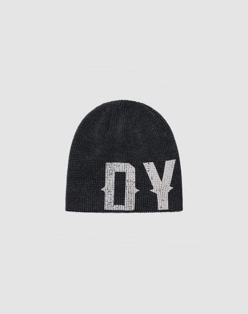 The DY Waffle Beanie by LIVE FAST DIE YOUNG is a black knit beanie with bold white DY lettering and a handgefertigter Sprayeffekt, shown on a plain light gray background.