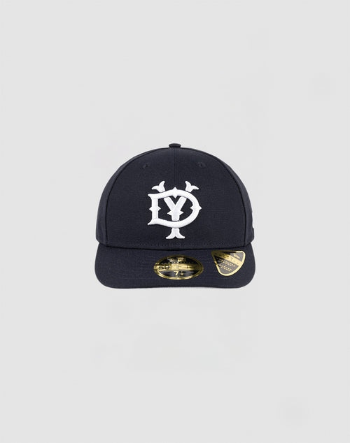 The LFDY x NEW ERA 59FIFTY Low Profile by LIVE FAST DIE YOUNG is a black fitted cap featuring a white DY logo with small birds, gold stickers on the flat brim, and a sleek low-profile silhouette for a modern style.