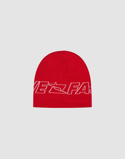 The Live Fast Jacquard Beanie by LIVE FAST DIE YOUNG is a red knit Polyacryl beanie with a white abstract logo and text design, partially reading VE FAS, shown on a light gray background.