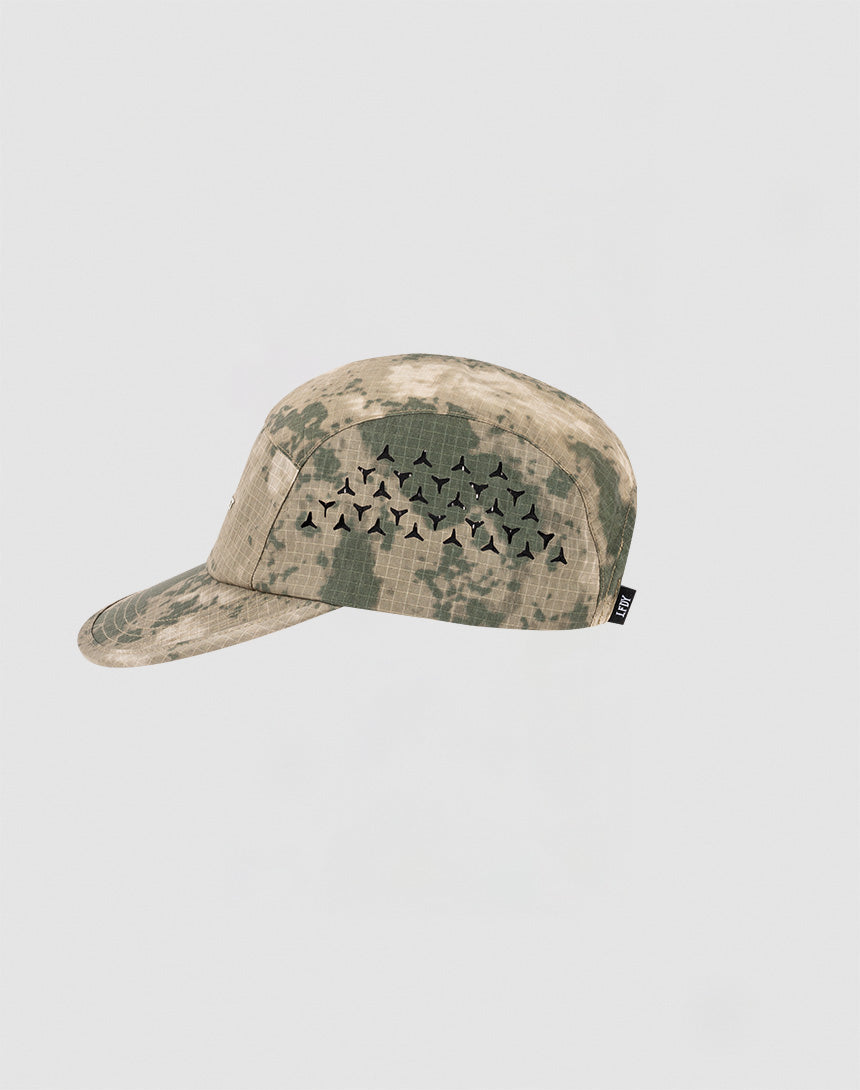 The LIVE FAST DIE YOUNG Live Fast 5 Panel Cap is a camouflage-patterned nylon cap with a cluster of black geometric air holes on the side, shown against a plain light gray background.