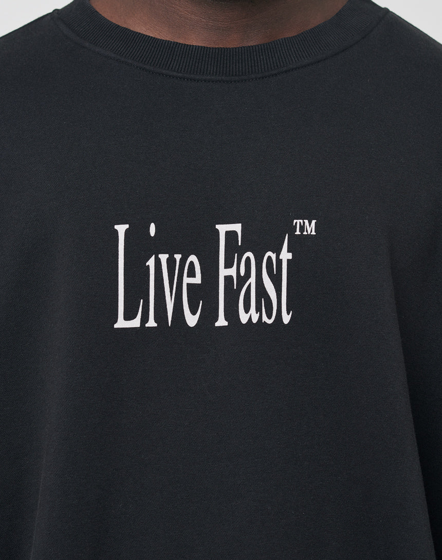 A close-up of a black Death Before Dishonor Sweater by LFDY, featuring large white Live Fast™ lettering on the front.
