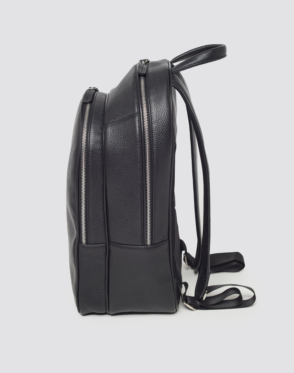 Side view of the LIVE FAST DIE YOUNG LFDY Leather Backpack in black, featuring two zippered compartments, adjustable shoulder straps, and a top handleāideal for your laptopāshown against a plain white background.