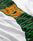 A close-up of the LIVE FAST DIE YOUNG No Rich Parents Longsleeve, a white 100% Baumwolle regular fit shirt with bold green, black, and orange diagonal text; exact wording partly obscured.