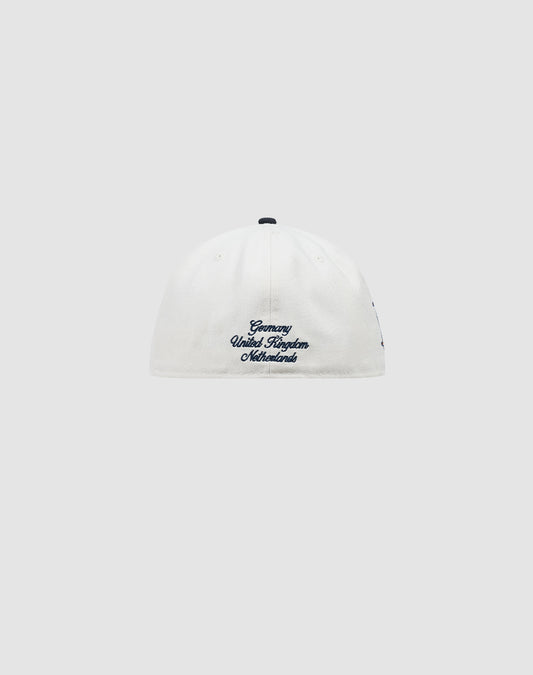 A white LFDY X NEW ERA 59FIFTY fitted cap by LIVE FAST DIE YOUNG, shown from the back with blue Germany United Kingdom Netherlands embroidery near the bottom. Plain light gray background. Größentabelle available for sizing.