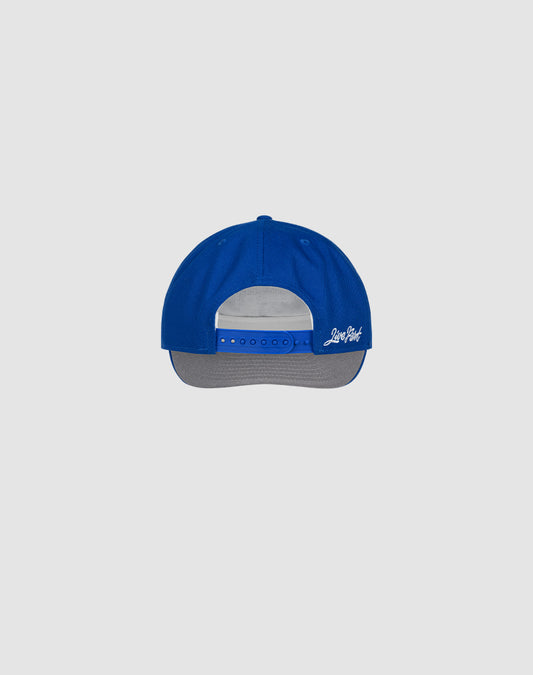 A blue and gray Custom LFDY X NEW ERA Monaco Boys snapback by LIVE FAST DIE YOUNG is shown from the back, featuring an adjustable strap and white side embroidery, inspired by the NEW ERA Retro Crown style, on a light gray background.