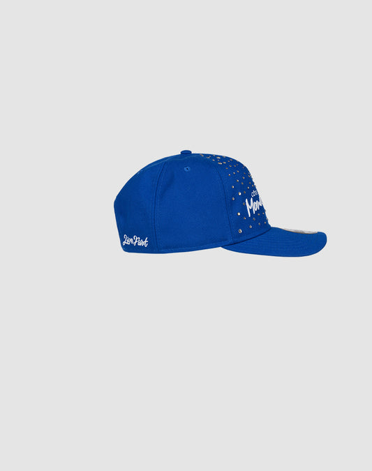 A vibrant blue Custom LFDY X NEW ERA Monaco Boys cap by LIVE FAST DIE YOUNG, featuring Moon and star embroidery on the front, is shown from the side against a light gray background—a standout hand-decorated Retro Crown style.
