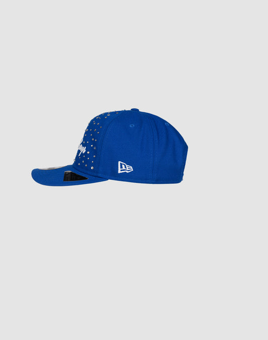 The Custom LFDY X NEW ERA Monaco Boys cap by LIVE FAST DIE YOUNG is shown from the side, featuring a blue design, flat brim, and white logo on the side, set against a plain light gray background.