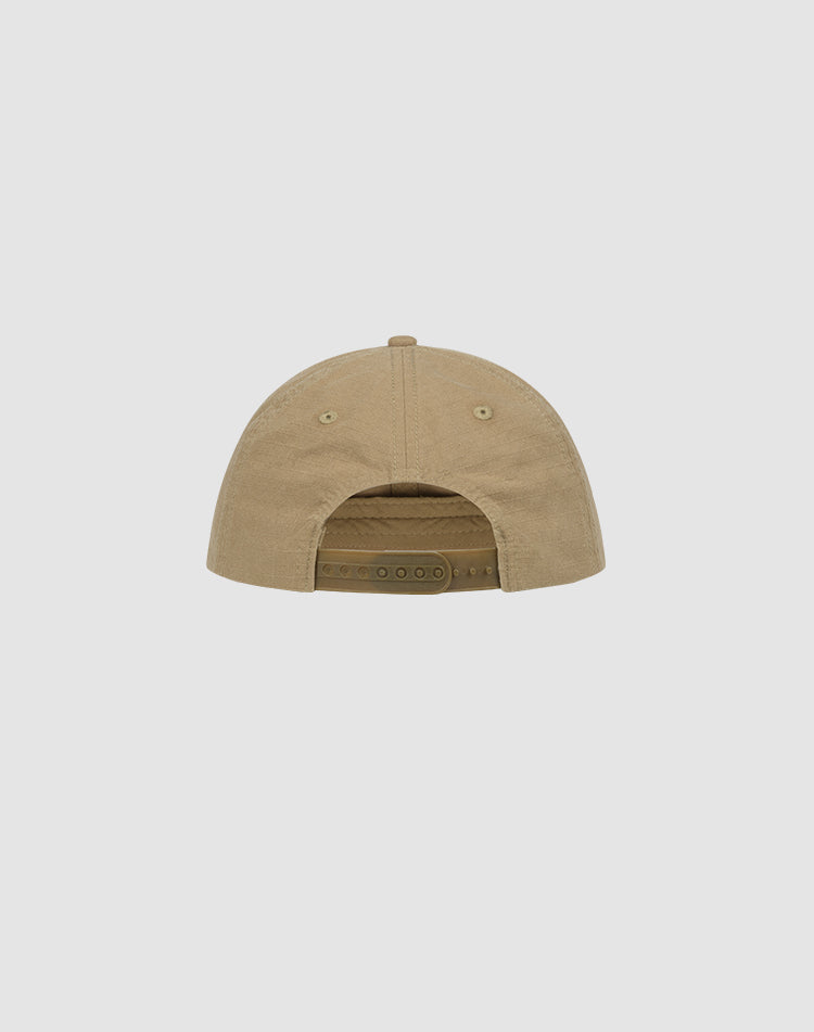 The Live Fast Paris Cap by LIVE FAST DIE YOUNG is a tan baseball cap shown from the back, featuring a Snapverschluss adjustable strap, two side ventilation holes, and is made of 100% Baumwolle. Displayed against a plain light gray background.