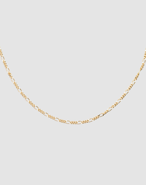 The Basic Figaro Chain by LIVE FAST DIE YOUNG is a delicate gold necklace made from 925 vergoldet Sterling Silber with an adjustable length, shown on a plain light gray background.