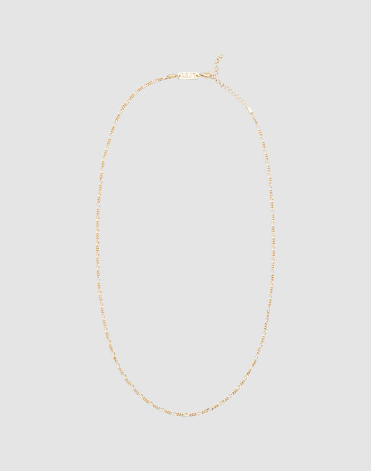 The LIVE FAST DIE YOUNG Basic Figaro Chain is a delicate 925 gold-plated necklace with an adjustable length and simple clasp, shown on a plain light gray background.