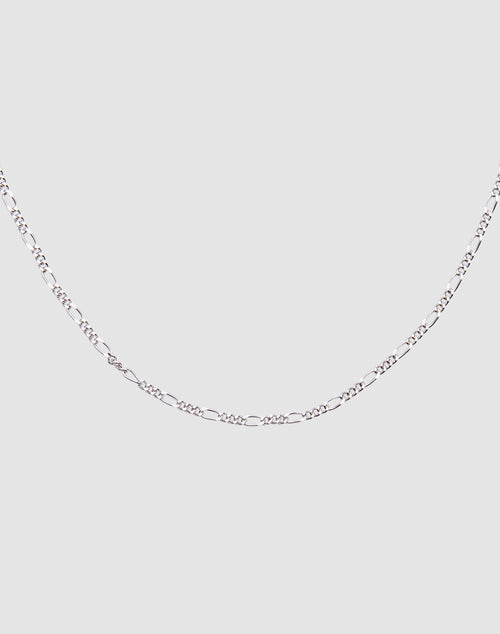 The LIVE FAST DIE YOUNG Basic Figaro Chain is a 925 Sterling Silver necklace featuring alternating elongated oval and small round links, shown against a plain light gray background.