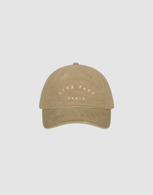 The Live Fast Paris Cap by LIVE FAST DIE YOUNG is a beige 100% Baumwolle baseball cap featuring "LIVE FAST" in white above "PARIS" on the front, shown against a plain light gray background.