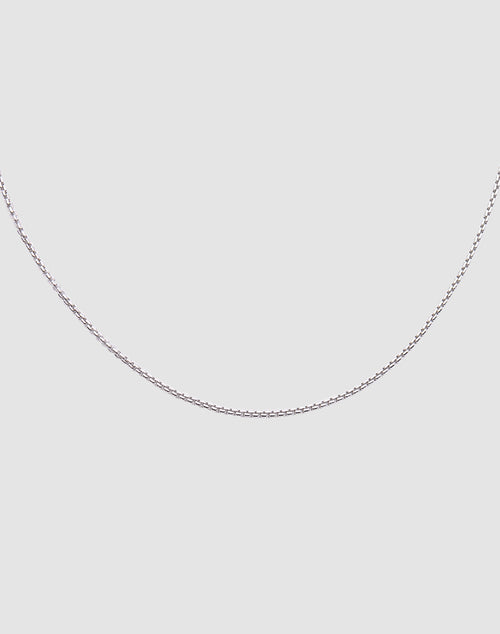 The LIVE FAST DIE YOUNG Thin Curb Chain, crafted from 925 Sterling Silver, is shown against a plain light gray background with only the lower half of the chain visible in a gentle curve.
