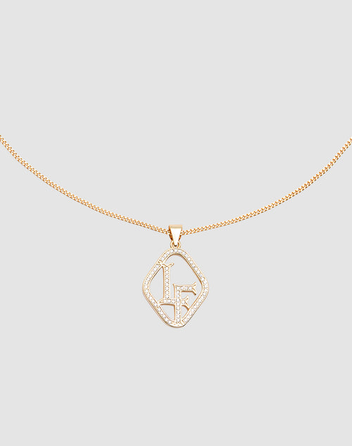 The LF Chain by LIVE FAST DIE YOUNG is a delicate gold necklace with a Zirkonia Anhänger displaying the initials LF in sparkling crystals, set against a light gray background.