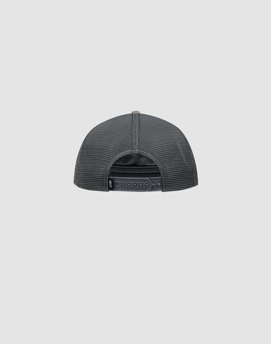 The LFDY Rivet Trucker by LIVE FAST DIE YOUNG is a black mesh trucker cap, shown from the back with an adjustable snapback closure and a subtle flag-label detail, set against a plain light gray background.