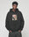A young man with short curly hair wears the LFDY Sharkhunter Hooded by LIVE FAST DIE YOUNG, featuring front and back prints, posing with his hands in his pockets against a plain light background.