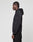 A person with cornrow braids stands in profile, wearing an oversized black LIVE FAST DIE YOUNG LFDY Paris Hooded Zip made from Baumwolle Polyester and black pants, set against a plain light gray background.