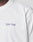 A close-up shows part of a persons shoulder and neck wearing the LIVE FAST DIE YOUNG Live Fast Paris Tee, a white 100% cotton T-shirt featuring “Livé Fast” in small blue and pink text on the left chest.