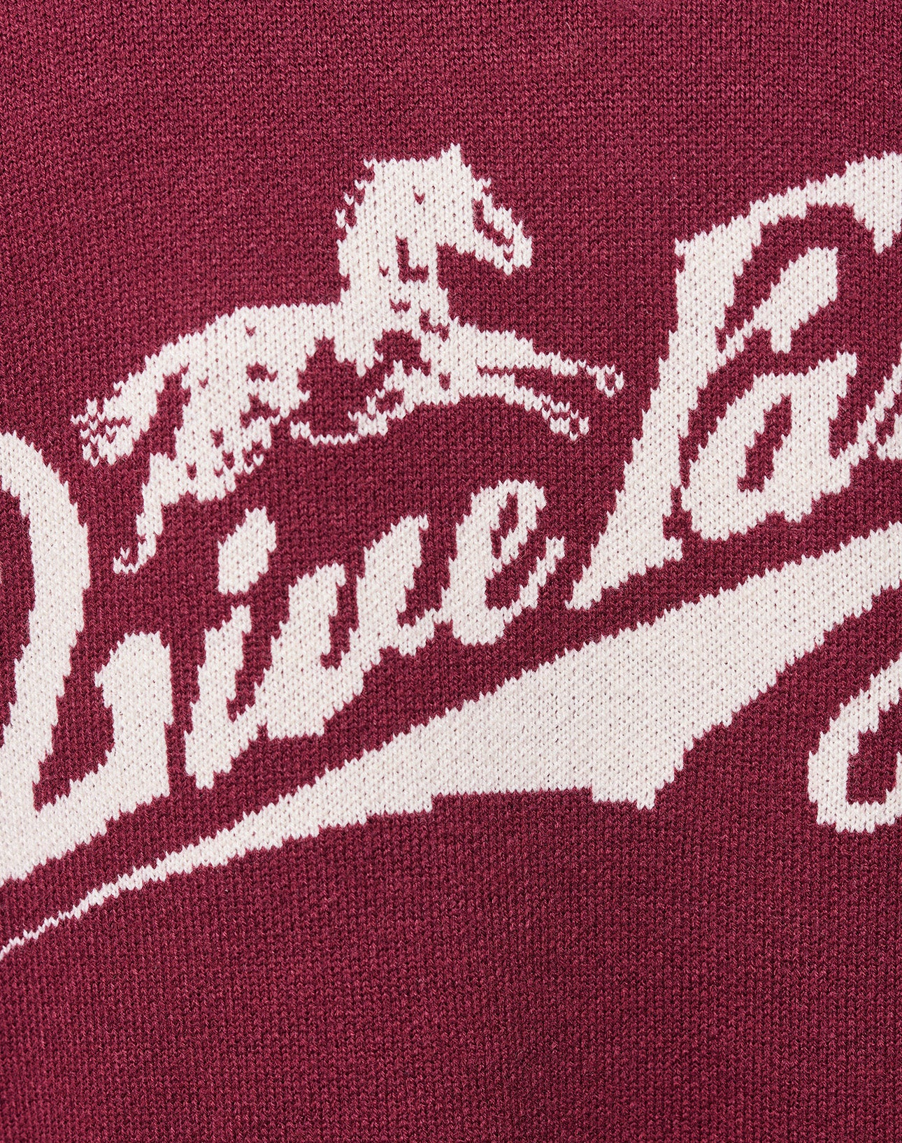 Close-up of a maroon Boxy Knit Zip Jacket by LIVE FAST DIE YOUNG, with white galloping horse graphic and “Live Fast” in cursive above it, in an Oversize Fit.