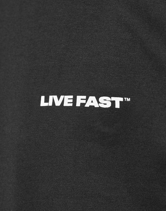 Close-up of the Live Fast Plain Tee by LIVE FAST DIE YOUNG, a black Regular Fit made from 100% cotton, featuring a bold white LIVE FAST™ front print.
