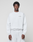 A young man stands against a plain light gray background wearing the LIVE FAST DIE YOUNG Basic +49 Chest Sweater and matching sweatpants, featuring a subtle chestprint near the left shoulder. He looks directly at the camera with a neutral expression.